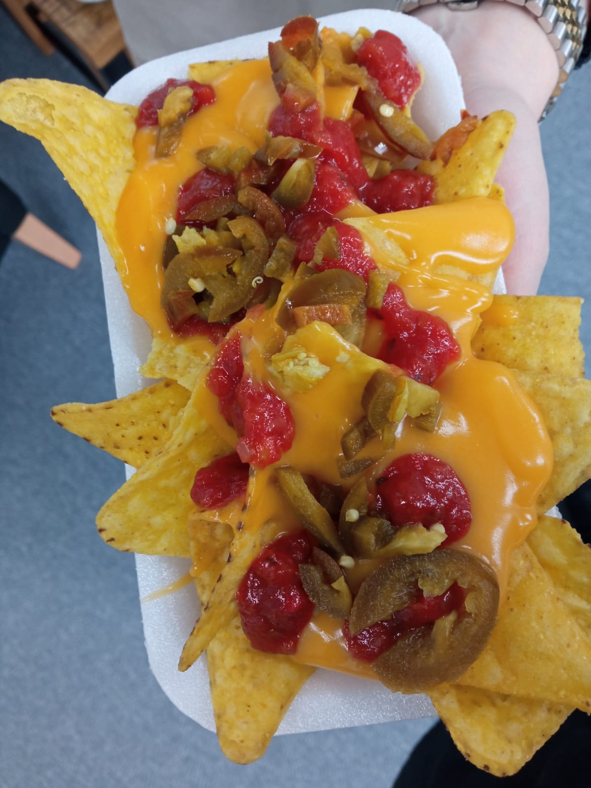 Nachos with cheese sauce and jalapeños
