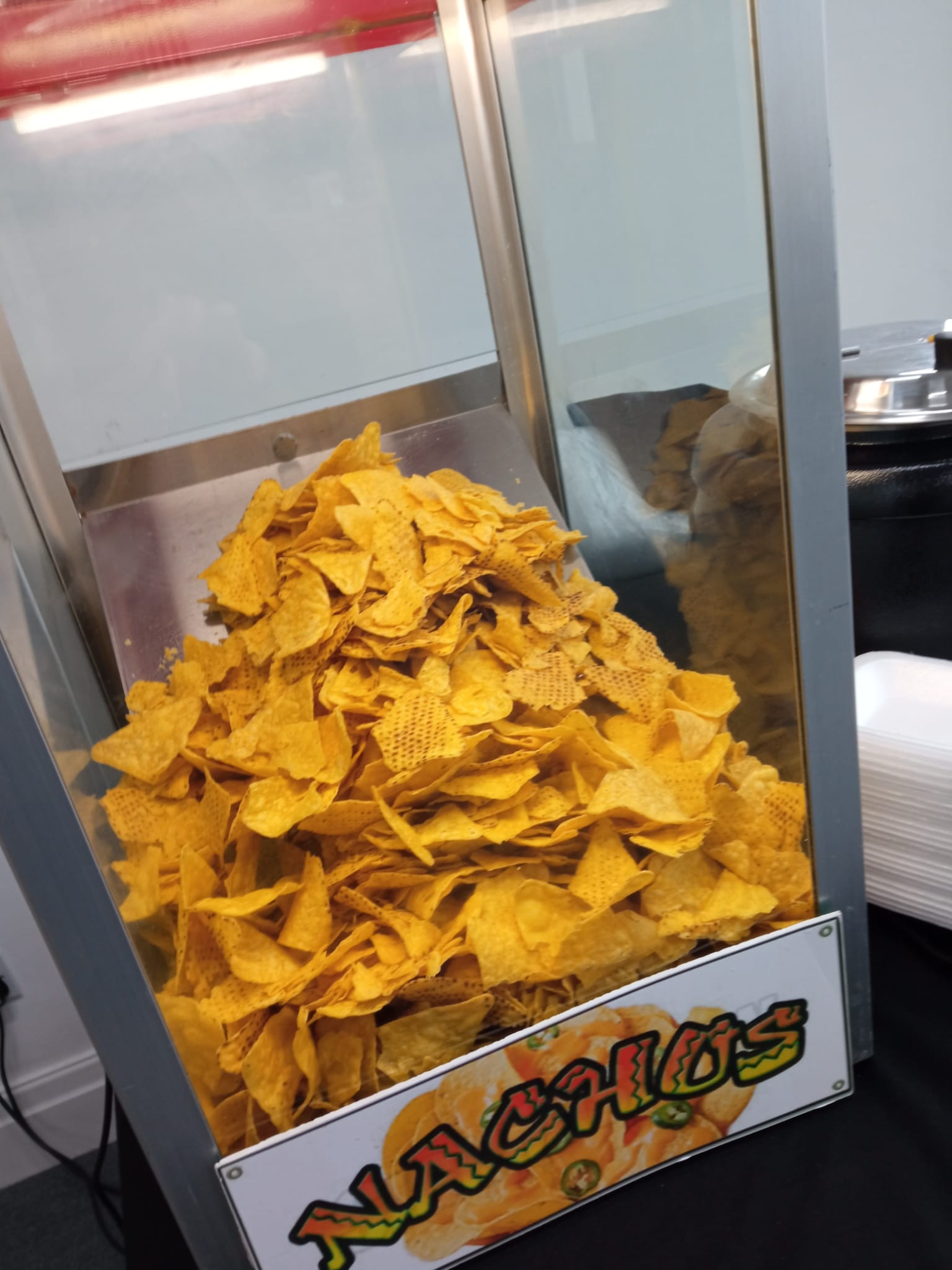 Nacho machine full of warm tortilla chips