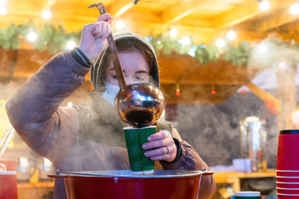 Glasses of hot mulled wine with orange and spices