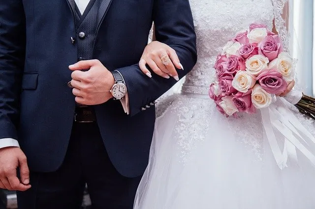 Bride and groom holding hands at a wedding